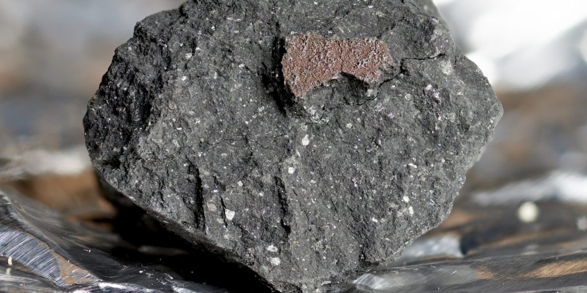 Undated handout photo issued by the Natural History Museum of a fragment from a meteorite, likely to be known as the Winchcombe meteorite, which is an extremely rare type called a carbonaceous chondrite. Issue date: Tuesday March 9, 2021.