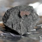 Undated handout photo issued by the Natural History Museum of a fragment from a meteorite, likely to be known as the Winchcombe meteorite, which is an extremely rare type called a carbonaceous chondrite. Issue date: Tuesday March 9, 2021.